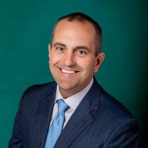 Professional headshot of male wearing suit and tie