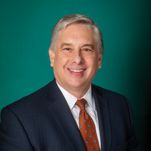 Professional headshot of male wearing suit and tie