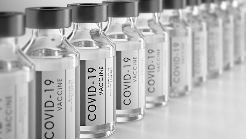 A line of vaccine vials labeled to indicate covid-19 vaccines