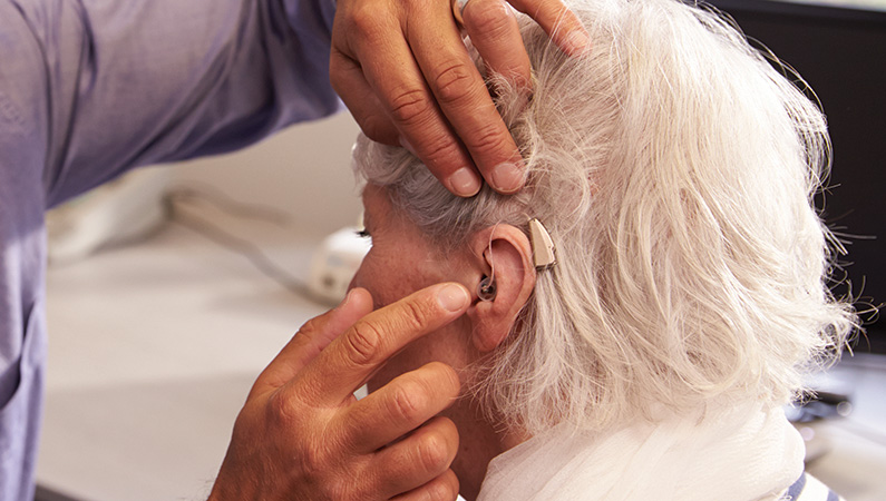 Patient getting ears and hearing aids checked