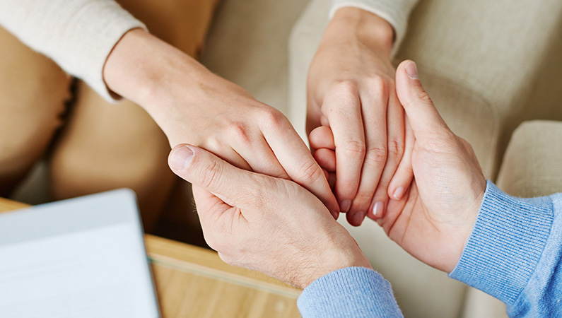 Two people holding hands