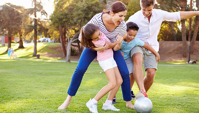Young family playing outside together