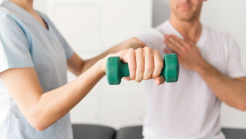 Patient and medical professional performing arm rehabilitation exercises