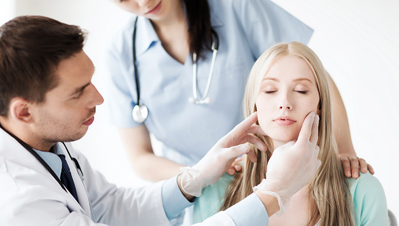 Young patient getting a consultation with two medical professionals