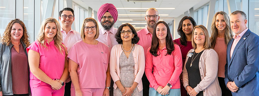 Group of health care clinicians supporting breast cancer wearing pink