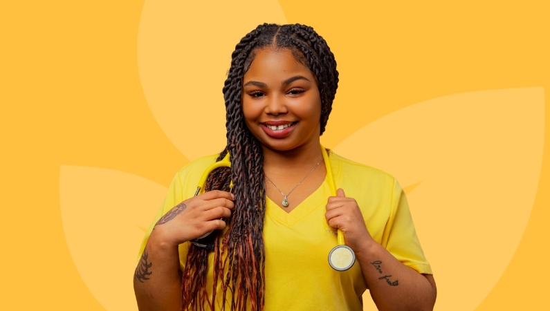 Female clinical support assistant smiling wearing yellow scrubs