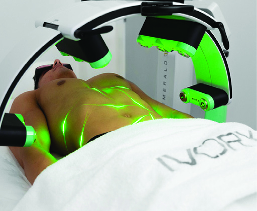 Man laying on medical table receiving Emerald Laser treatment.