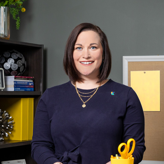 Female smiling in business office setting.