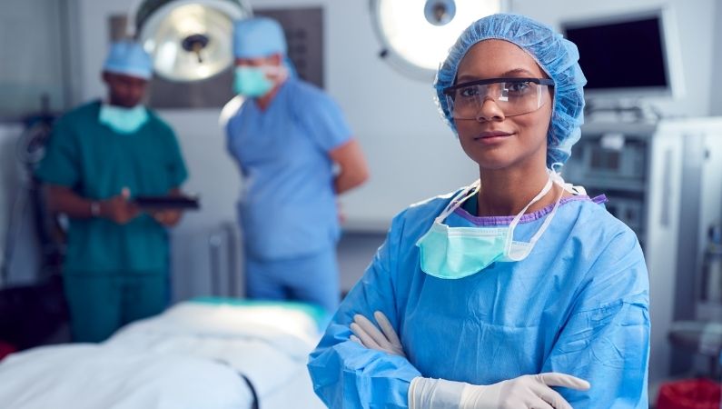 Medical professional in OR setting wearing scrubs