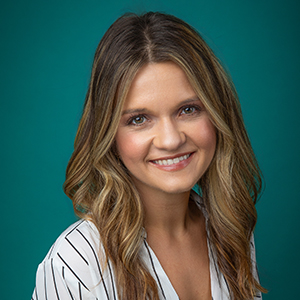 Female behavioral health therapist smiling in professional headshot.