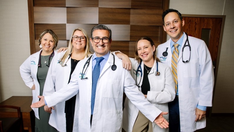 Pekin primary care group of providers smiling in medical clinic space