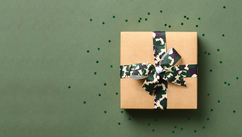 Gift wrapped in brown wrapping paper with a camo green bow.