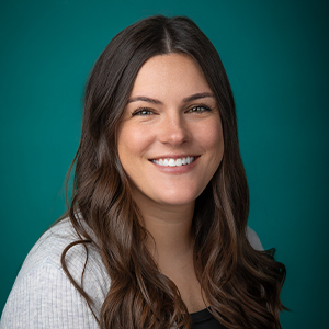 Female nurse practitioner smiling in professional headshot
