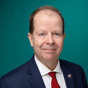 Male physician assistant smiling in professional headshot.