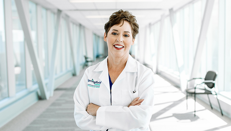 Woman smiling in a well lit walkway.