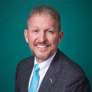 Male pediatrics doctor professional headshot.