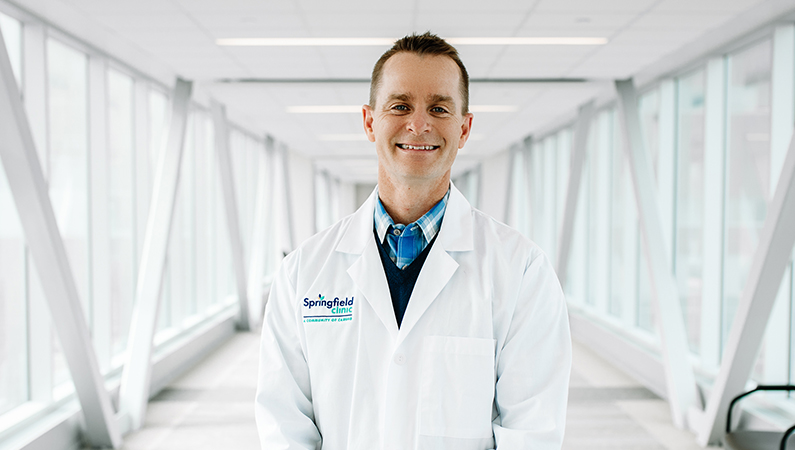 Man smiling in a well lit walkway.