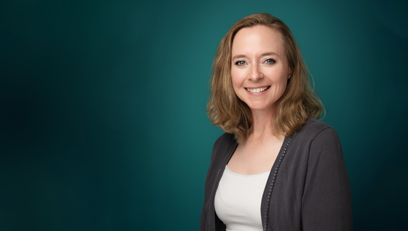 Female athletic trainer smiling in professional headshot.