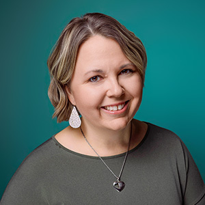 Female nurse practitioner smiling in professional headshot