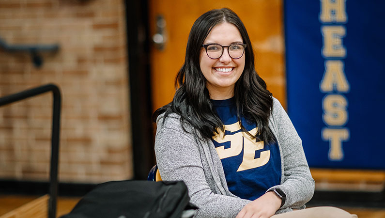 Female athletic trainer smiling in school gym