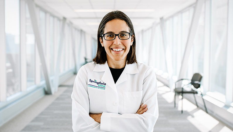 Woman smiling in a well lit walkway.