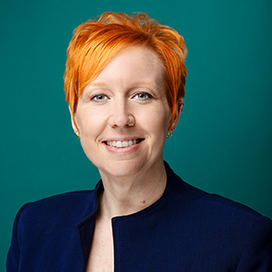 Female critical care nurse practitioner smiling in professional headshot.