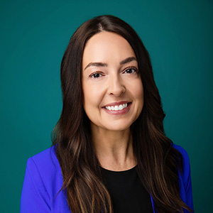 Female nurse practitioner smiling in professional headshot