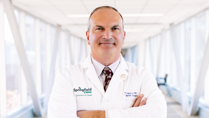 Man smiling in a well lit walkway.