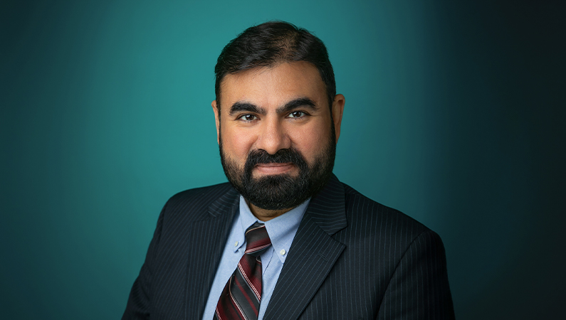 Male critical care medicine doctor smiling.