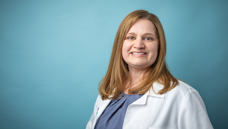 Female nurse practitioner smiling.