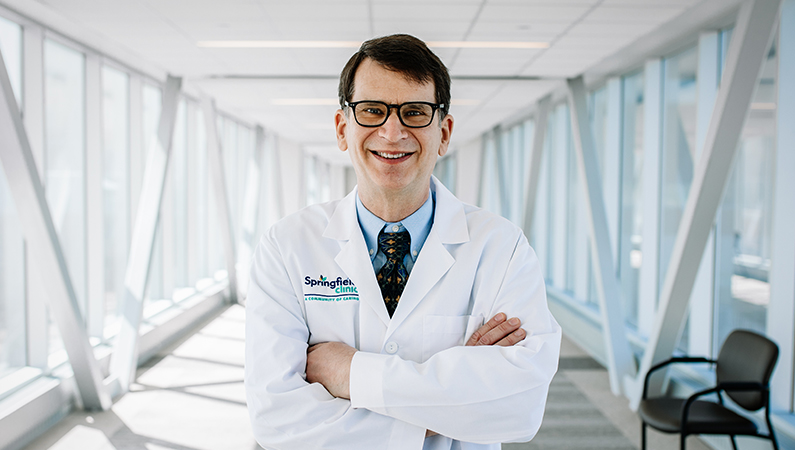 Man smiling in a well lit walkway.