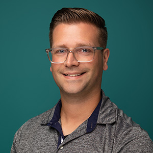 Male physician assistant smiling in professional headshot.