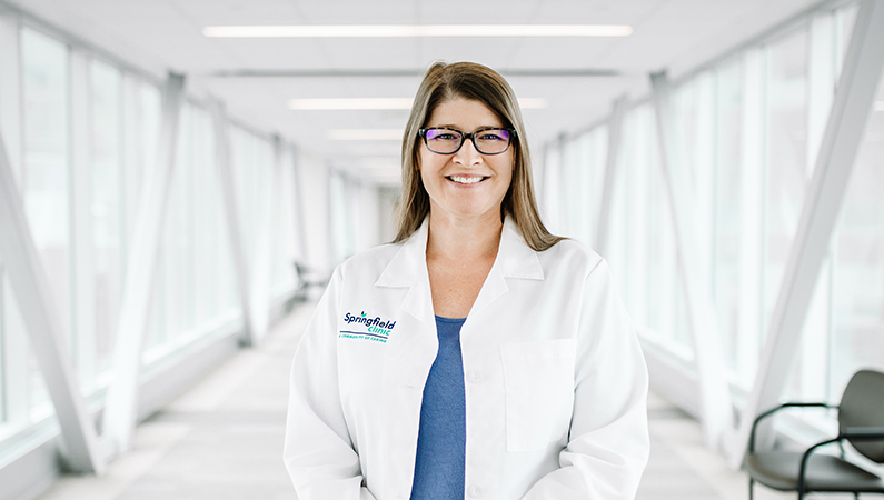 Woman smiling in a well lit walkway.