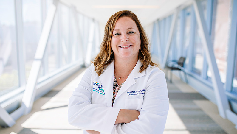 Woman smiling in a well lit walkway