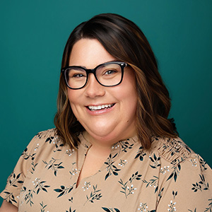 Female nurse practitioner smiling in professional headshot