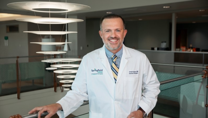 Man smiling in a well lit lobby.