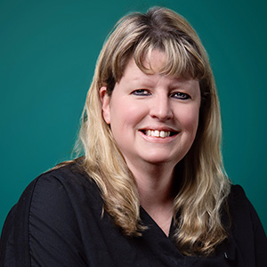 Female podiatrist smiling in professional headshot.