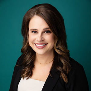 Female nurse practitioner smiling in professional headshot