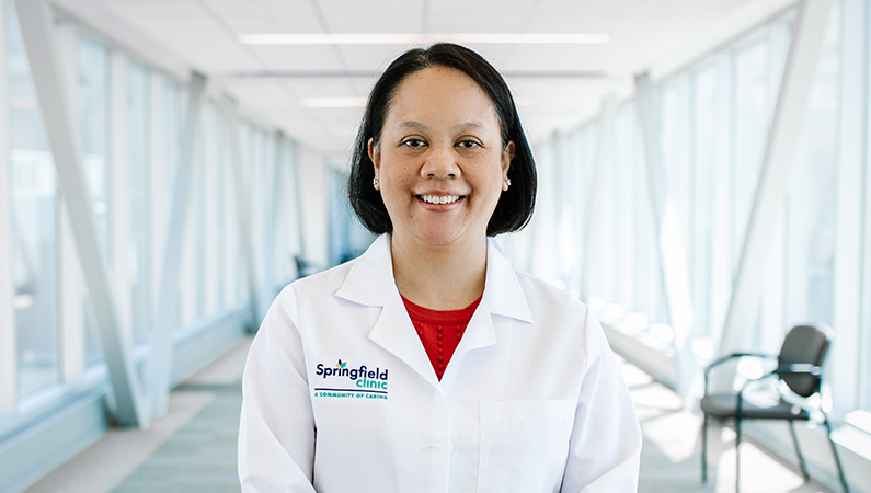 Woman smiling in a well lit walkway.