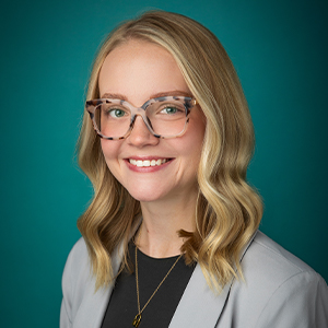 Female nurse practitioner smiling in professional headshot