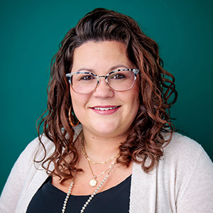 Female certified nurse midwife smiling in professional headshot.