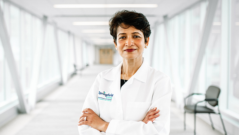 Woman smiling in a well lit walkway.