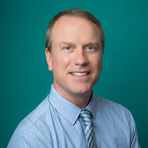 Male nurse practitioner professional headshot.