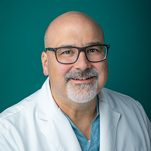 Male doctor smiling in professional headshot.
