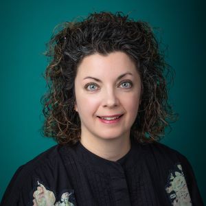 Female trauma surgeon smiling in professional headshot.
