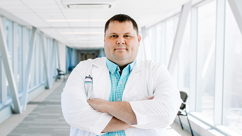 Man smiling in a well lit walkway.