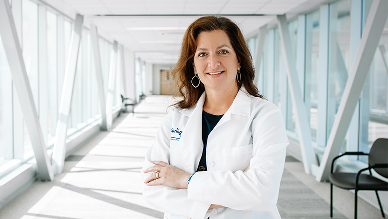 Woman smiling in a well lit walkway.