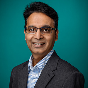 Male endocrinologist smiling in a professional headshot.