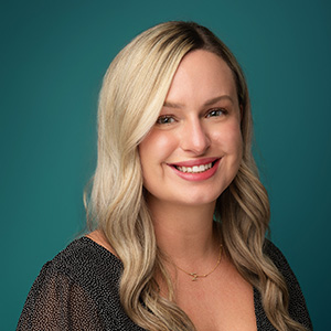 Female nurse practitioner smiling in professional headshot.
