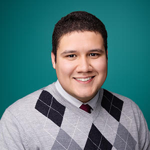 Male physician assistant smiling in professional headshot.